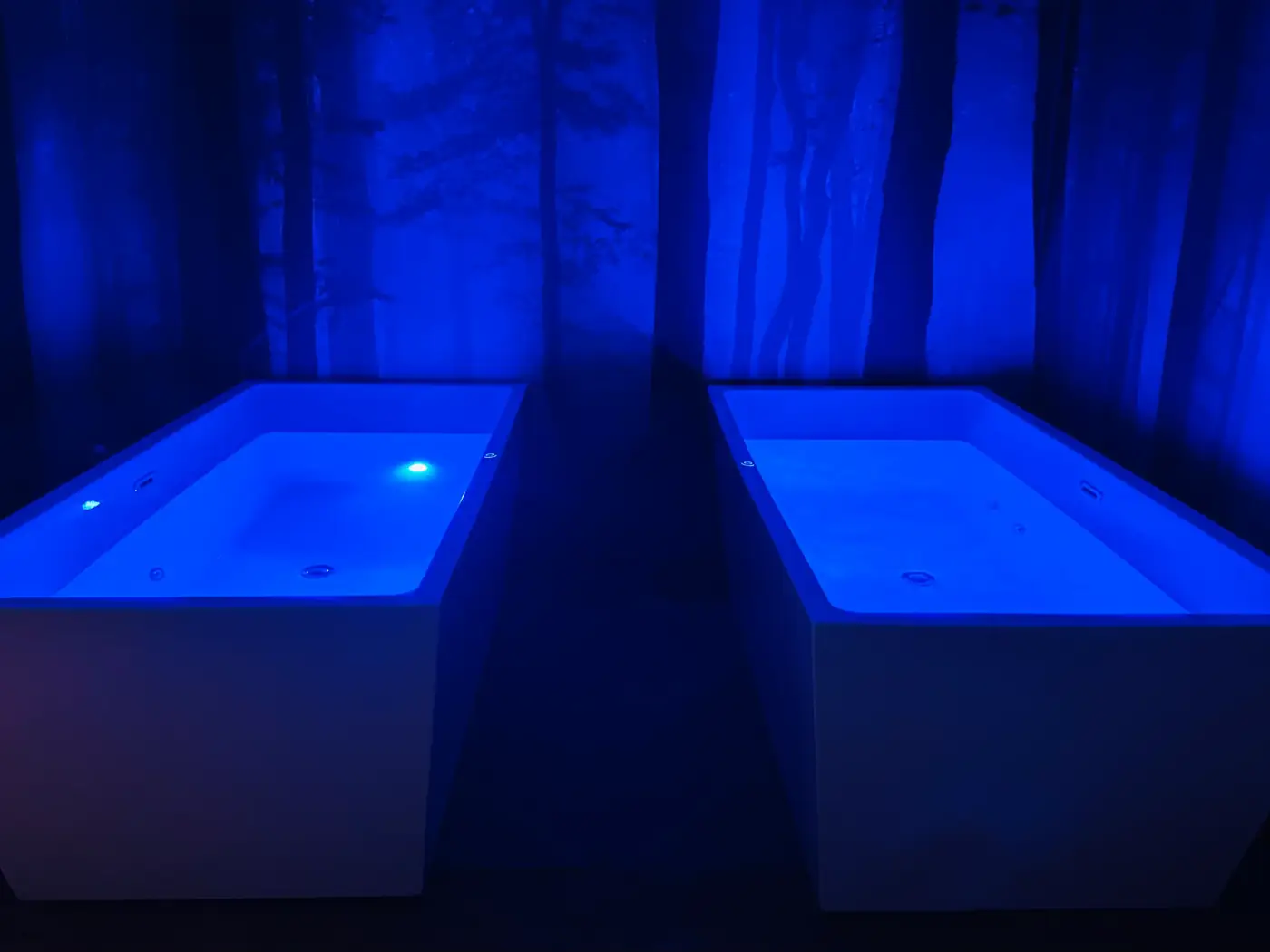 The cold plunge tubs lit blue