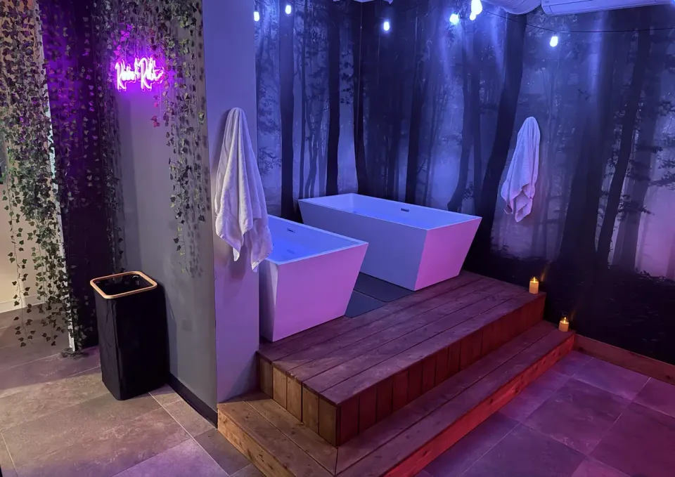 The recovery room: two cold plunge tubs, cedar steps and the forest wall